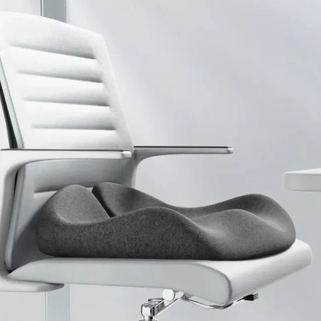 Gray seat cushion on a white office chair with a light gray background