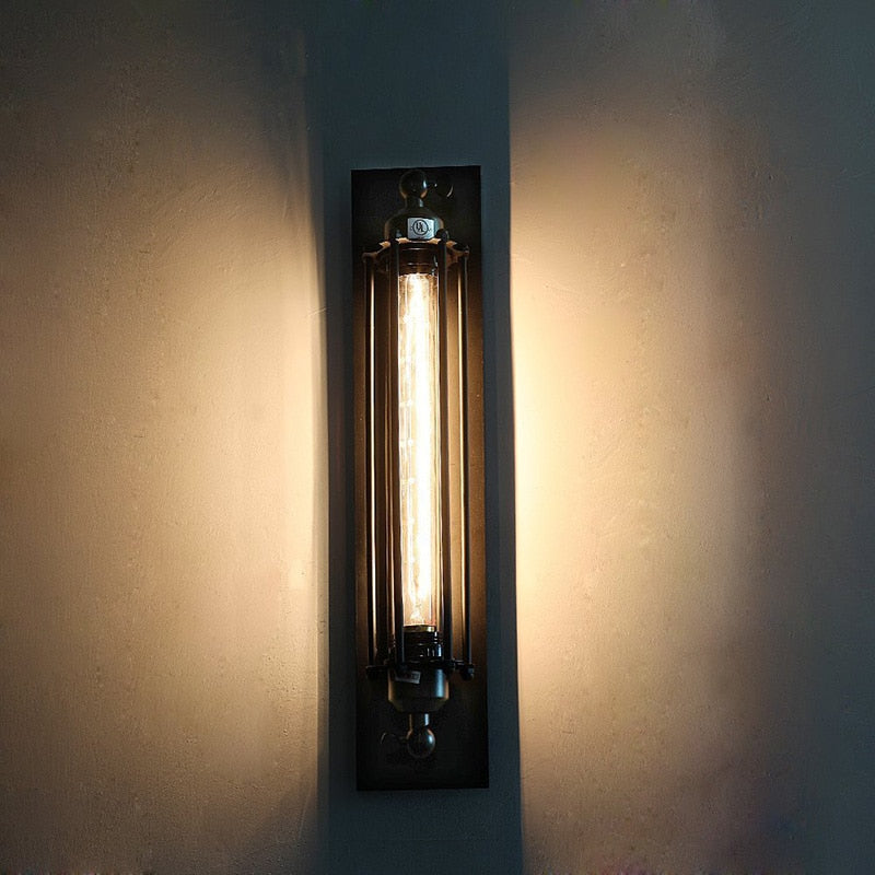 Wall-mounted light fixture casting a warm glow on a plain wall.