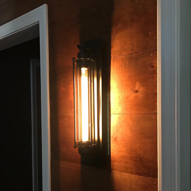 Wall-mounted light fixture casting a warm glow on a wooden wall.