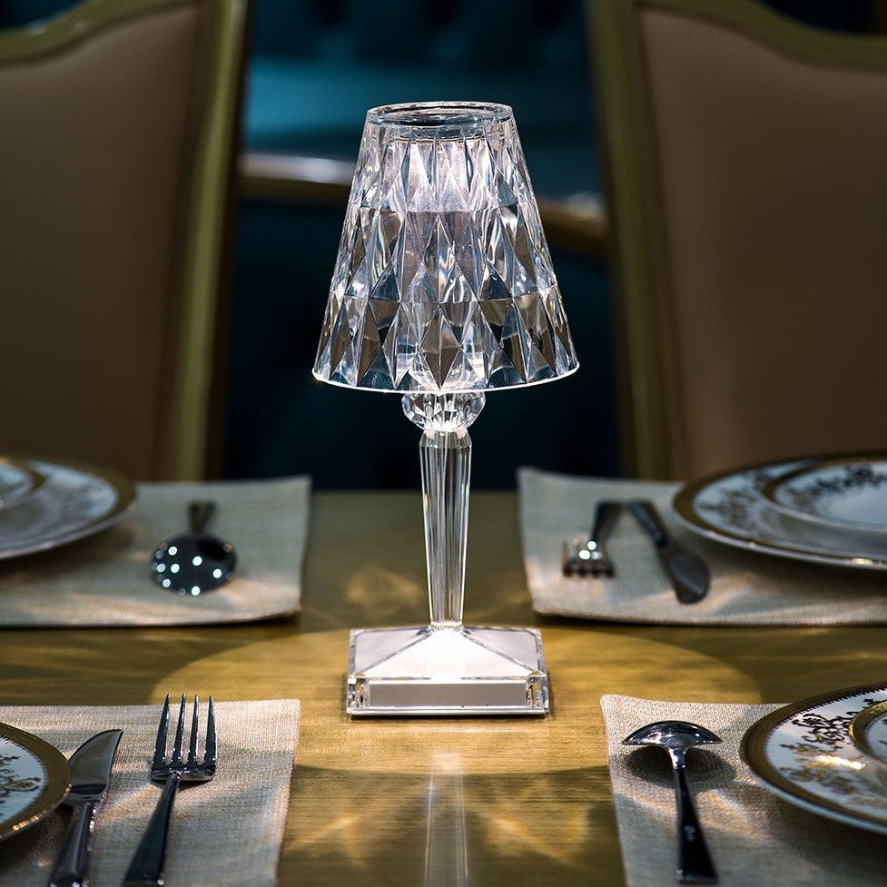 Crystal table lamp on a dining table with plates, cutlery, and napkins.
