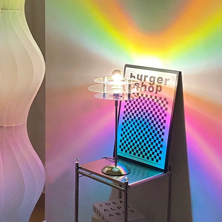 Futuristic burger stand with colorful light display against a rainbow-colored wall.