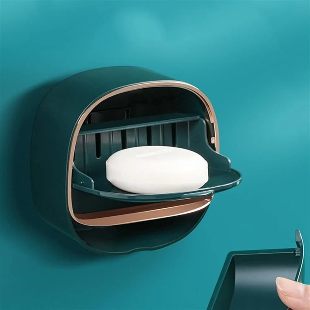 Wall-mounted soap dispenser with a bar of soap on a teal background