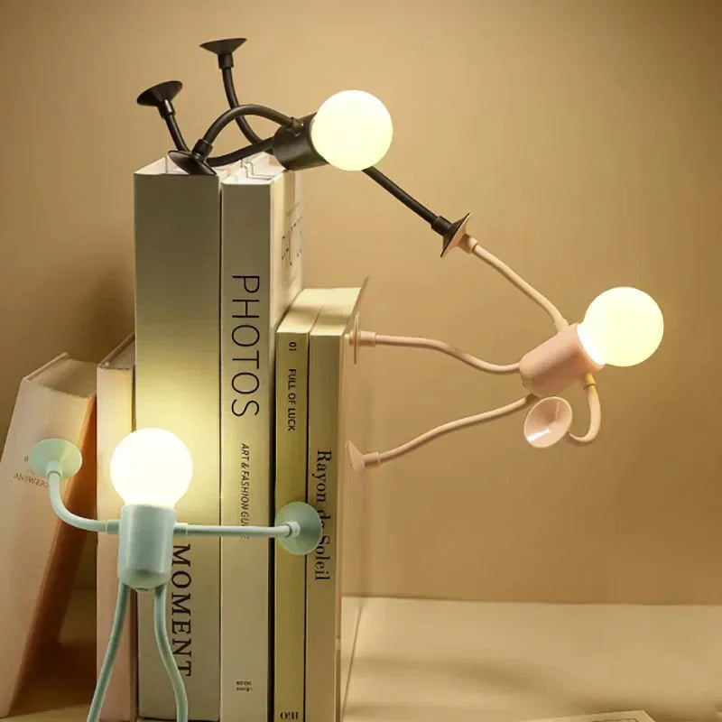 Modern lamp with multiple arms on top of books against a beige background