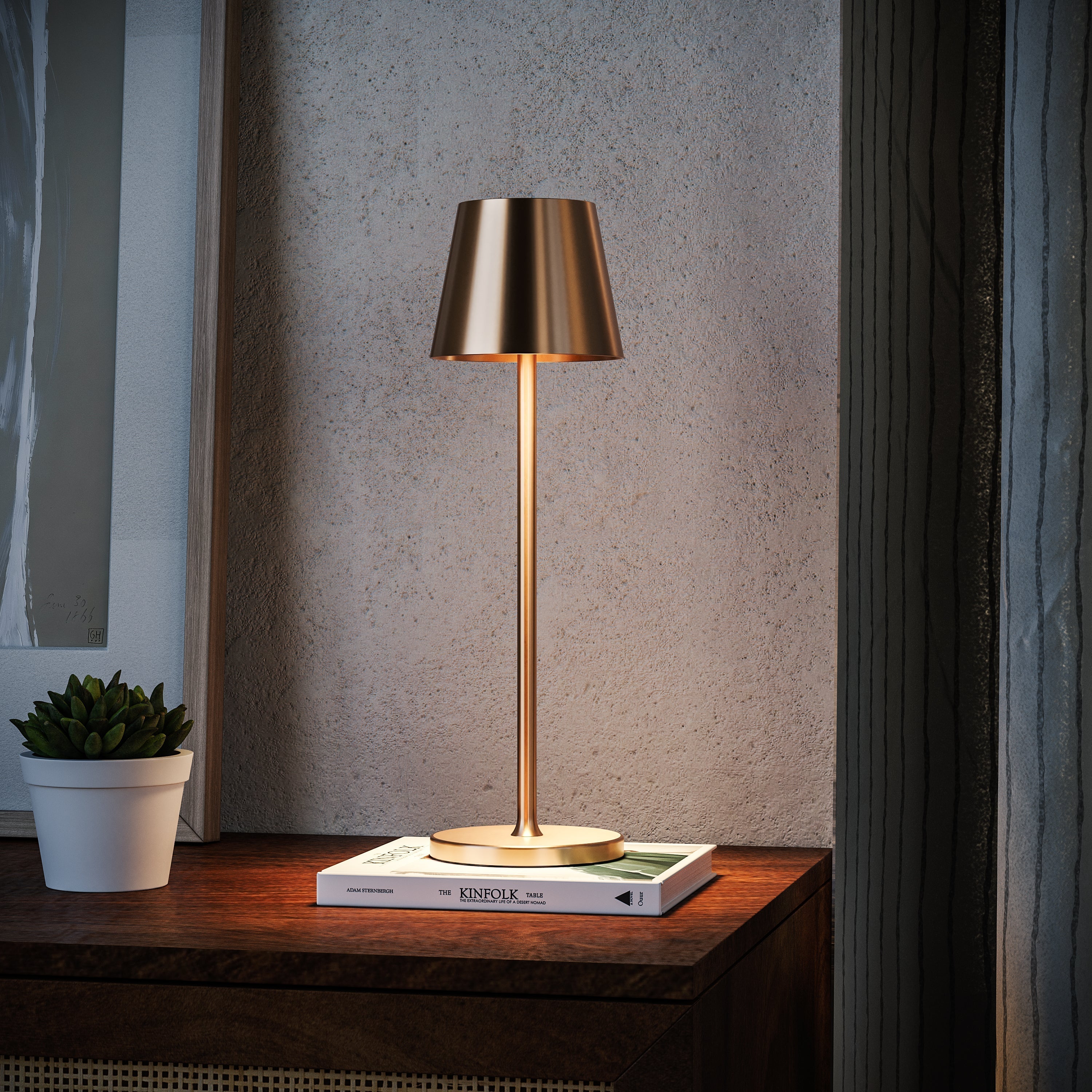 Gold table lamp on a wooden surface with a neutral background