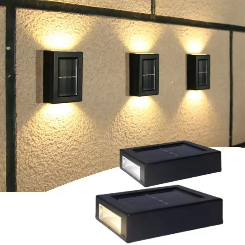 Three outdoor wall lights mounted on a textured wall with two additional lights below.