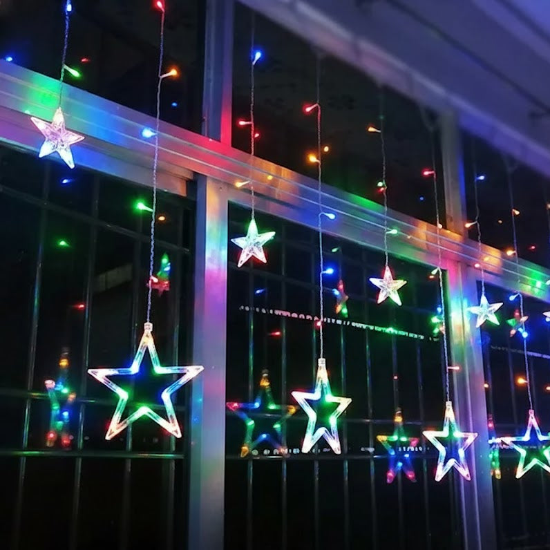 Star-shaped LED lights hanging against a dark background