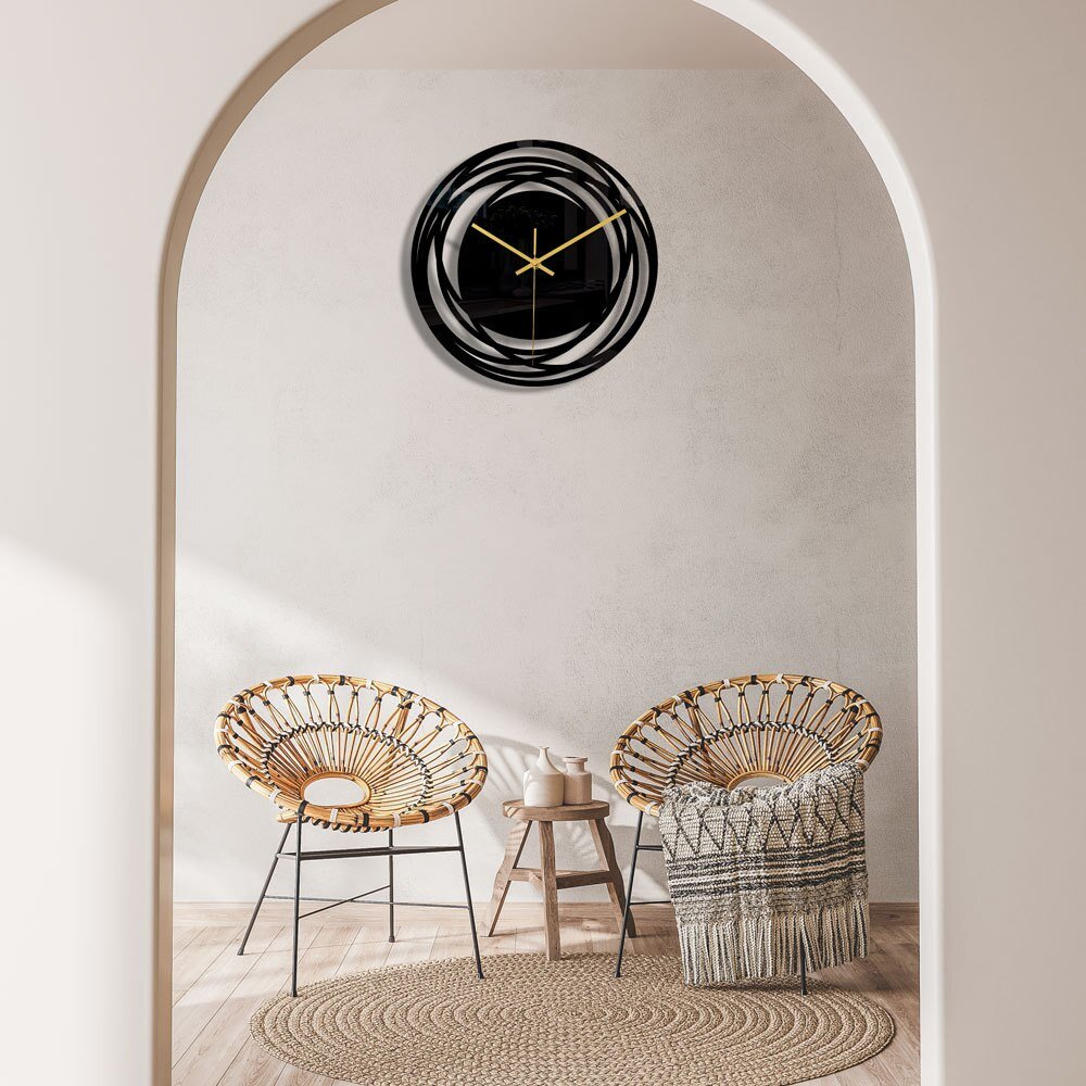 Decorative wall clock on a wall above two chairs in a room.