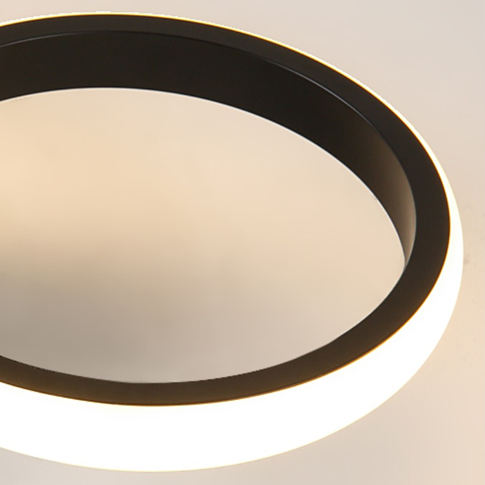 Close-up of a modern ceiling light fixture with a black frame.