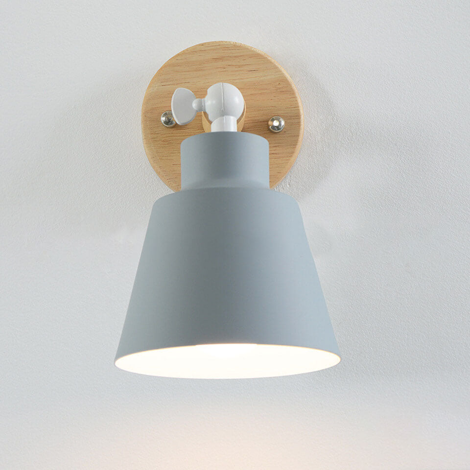 Wall-mounted light fixture with gray shade and wooden base on a white background
