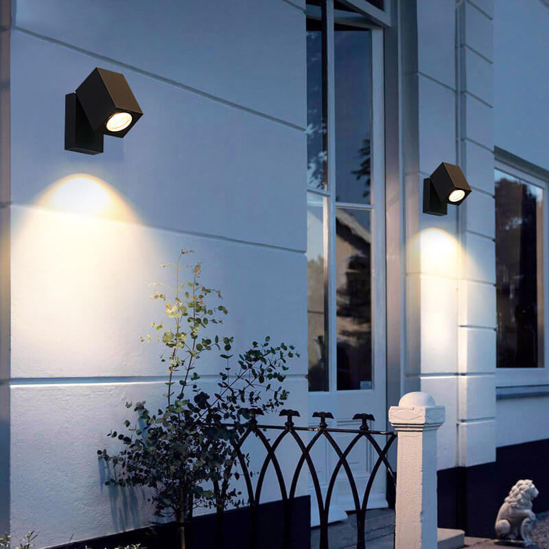 Modern outdoor setting with wall-mounted lights on a building facade.