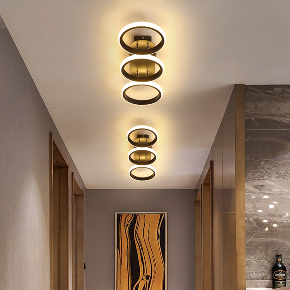 Modern ceiling light fixture with circular design in a room setting.