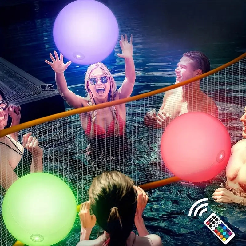 People in a pool with colorful floating balloons and a remote control.