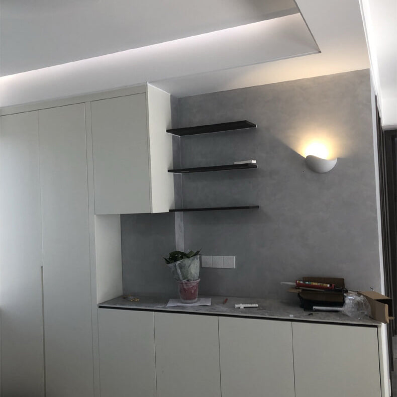 Modern kitchen with gray cabinets, a countertop, and wall-mounted shelves.