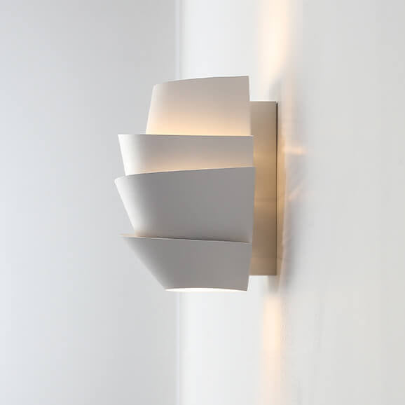 Modern wall-mounted light fixture with geometric design on a white background