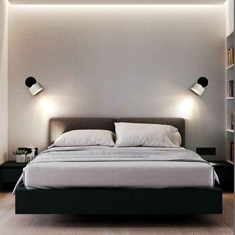 Modern bedroom with a bed, nightstands, and wall lights.
