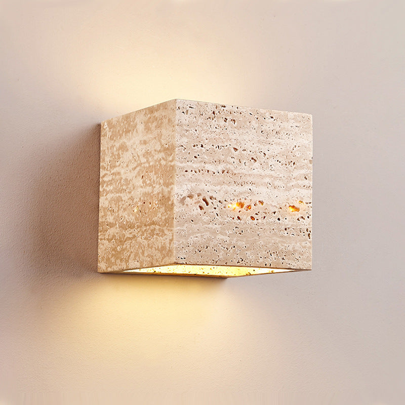Square stone wall light fixture on a neutral background