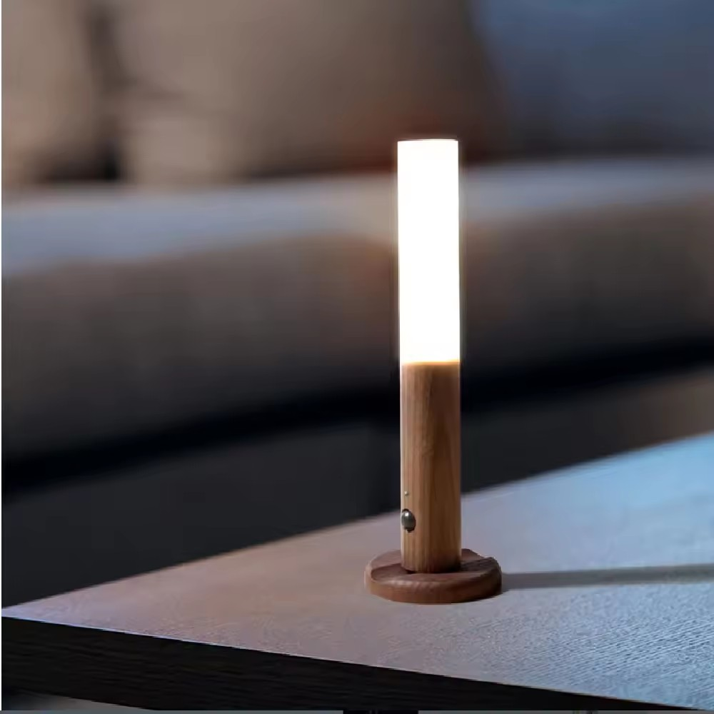 Wooden lamp with a white light bulb on a surface with a blurred background