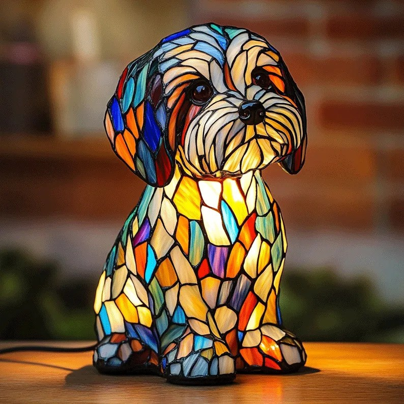 Colorful stained glass dog-shaped lamp on a wooden surface with a blurred background