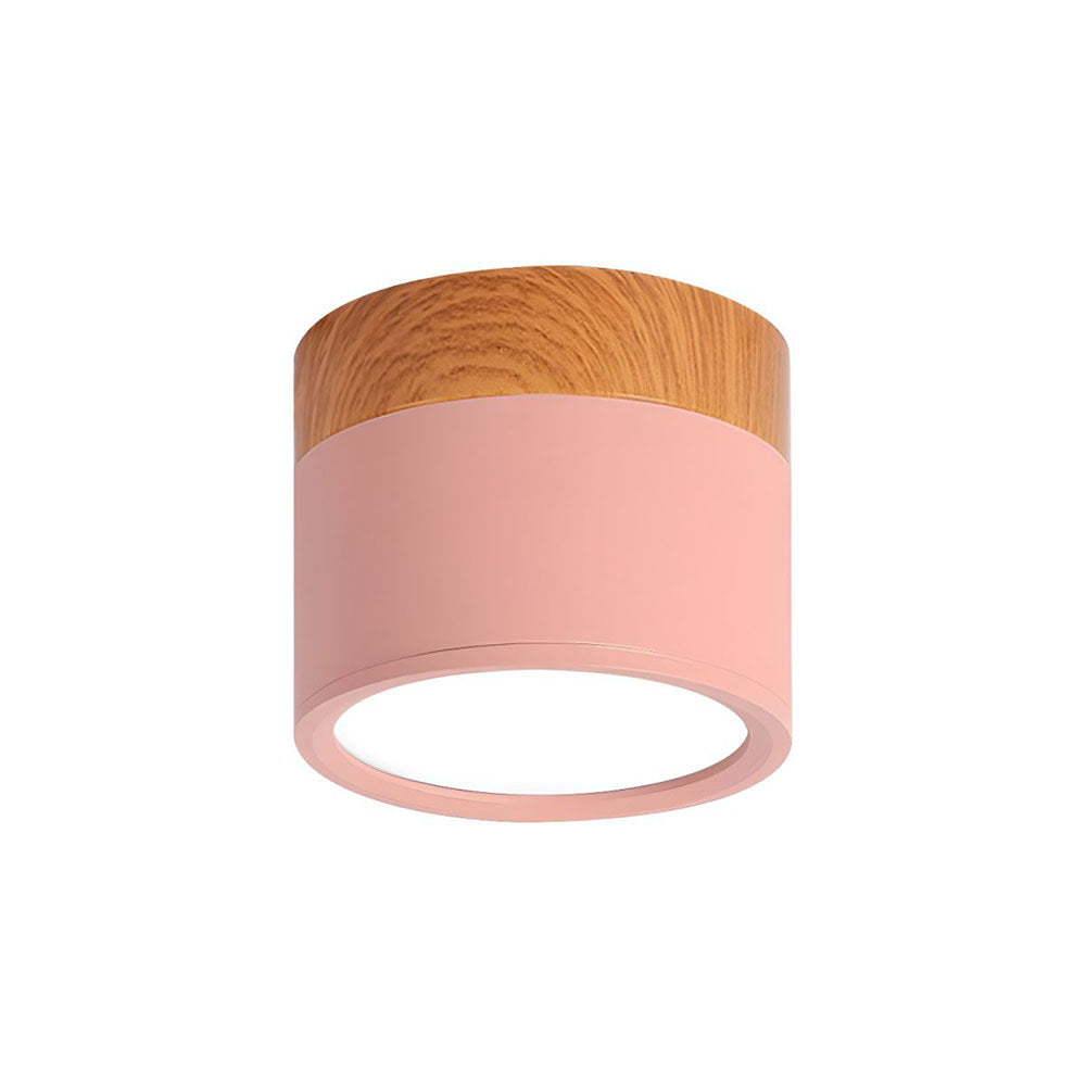 Ceiling light fixture with wooden top and pink base on a white background