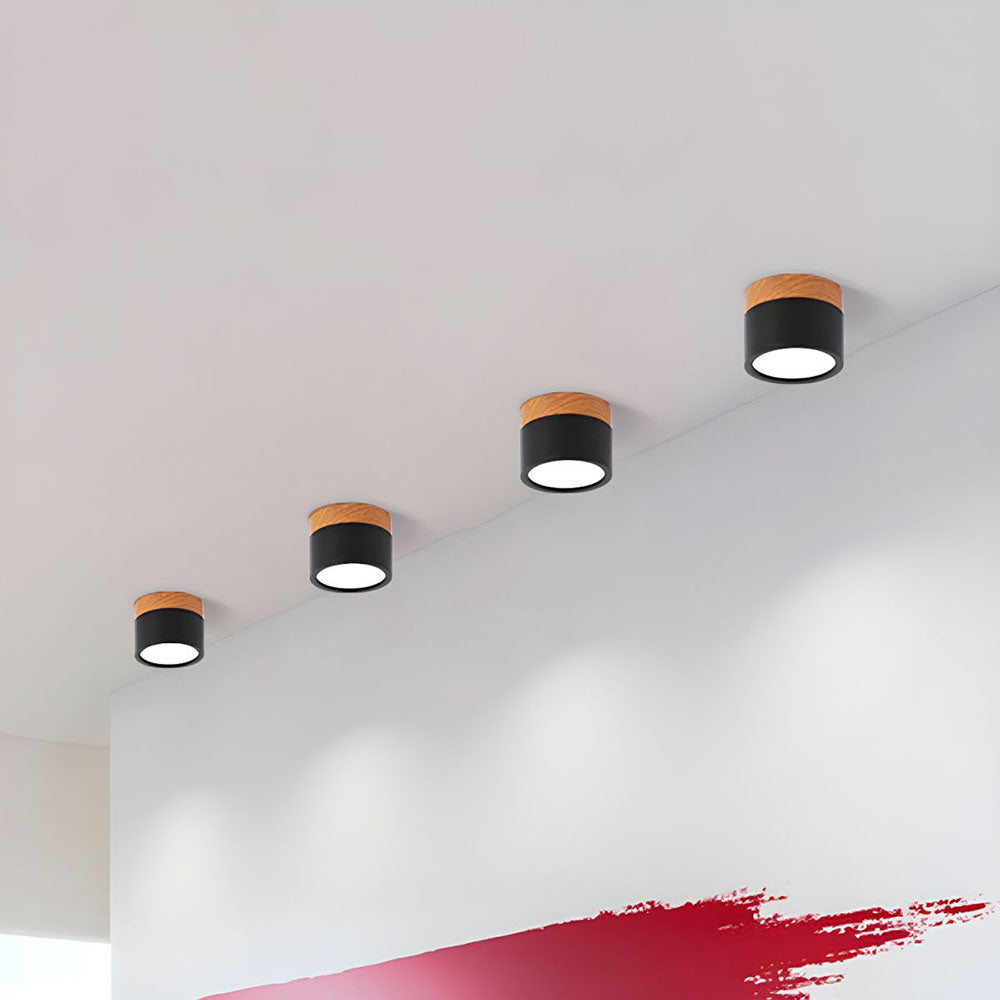 Ceiling lights on a white wall with a red accent
