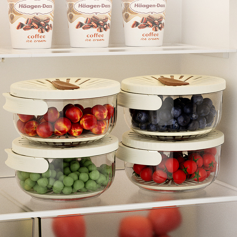 Set of food storage containers with fruits inside, placed on a refrigerator shelf.