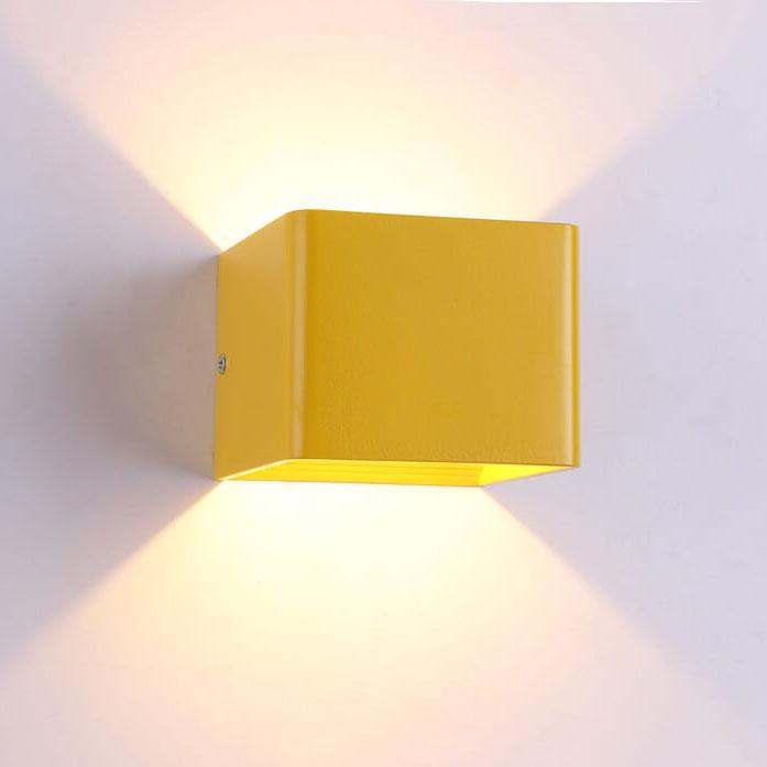 Yellow wall-mounted light fixture on a white wall