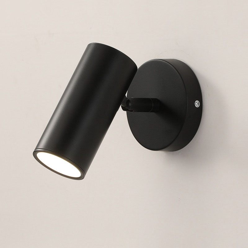 Black wall-mounted light fixture on a beige wall