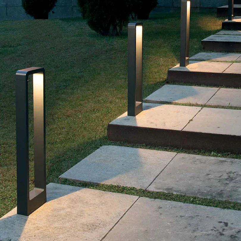 Outdoor garden lighting fixtures on stone steps and grass