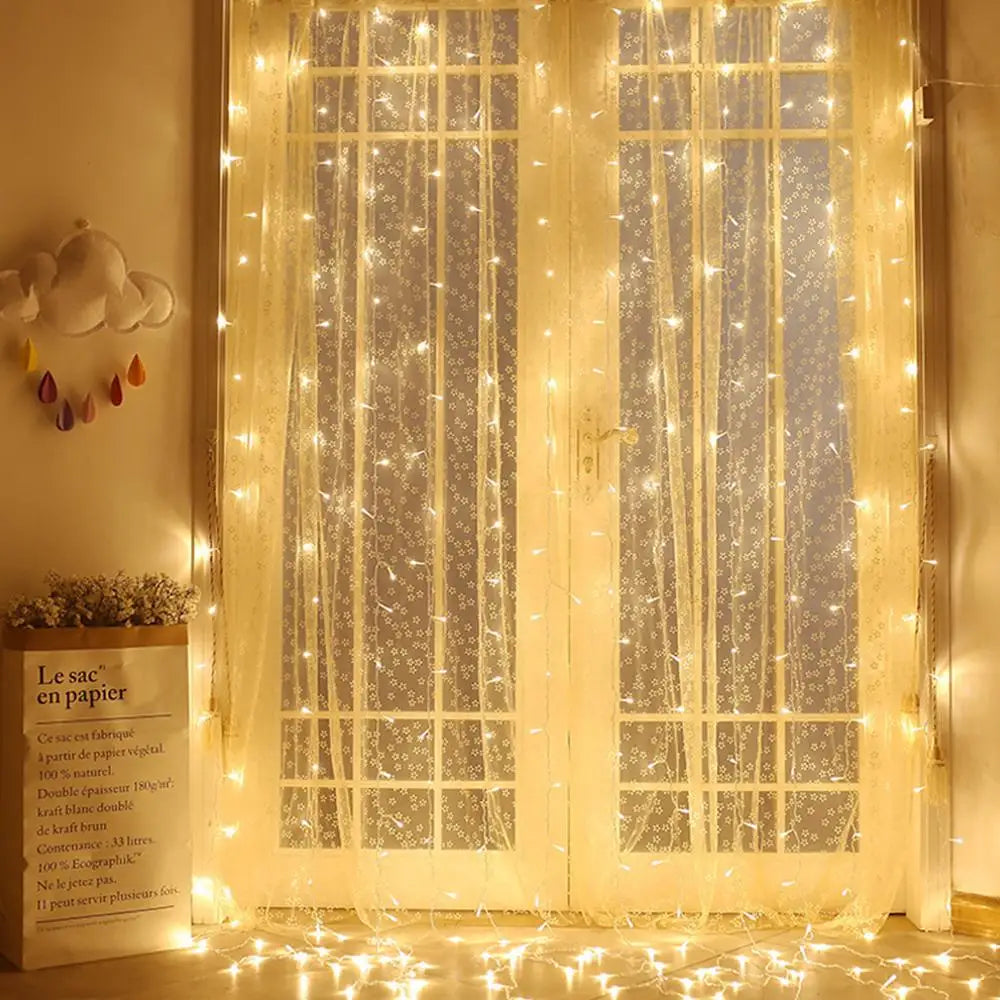 Window with fairy lights casting a warm glow in a room.