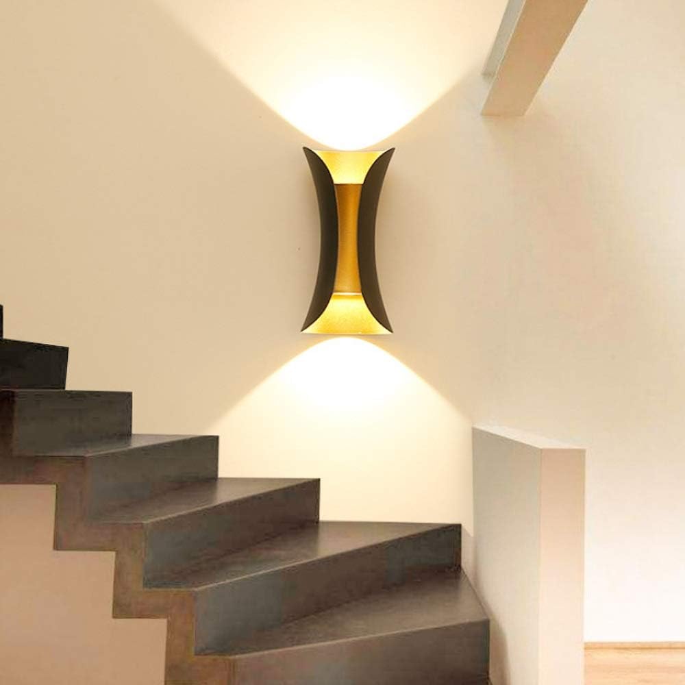 Modern staircase with a wall-mounted light fixture in a home interior.