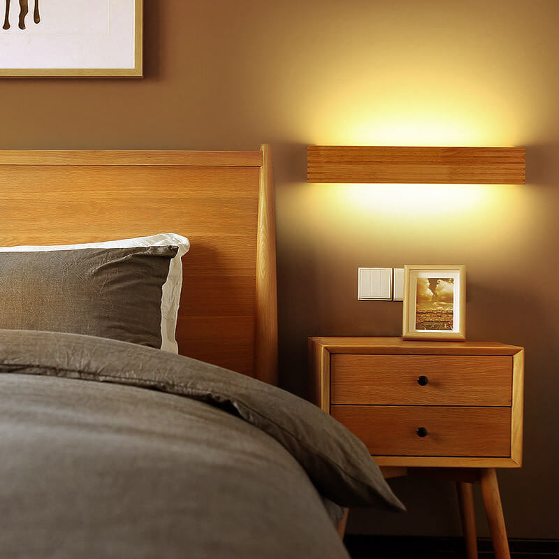 Bedroom with wooden headboard and nightstand, warm lighting