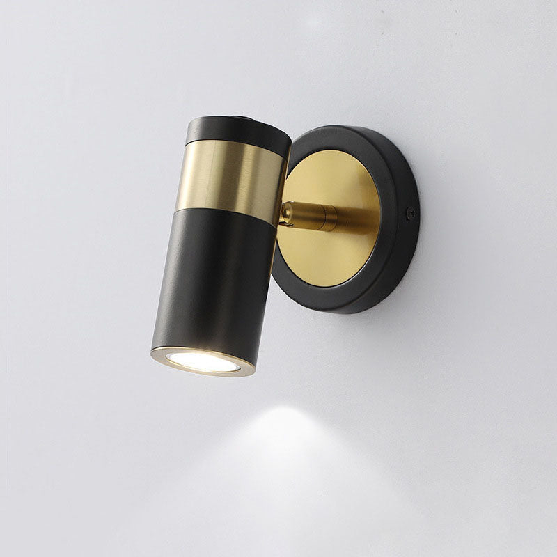 Modern wall light fixture with black and gold design on a white background