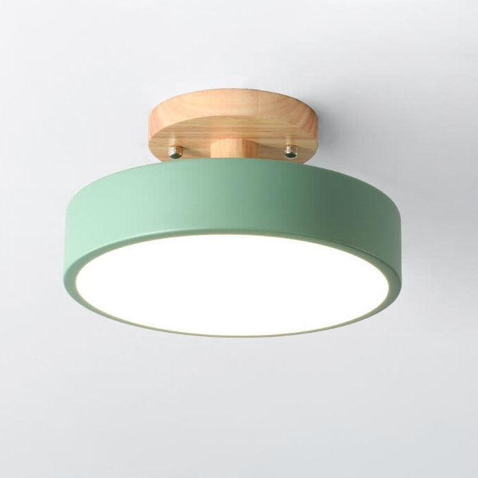 Ceiling light fixture with green shade and wooden finish on a white background