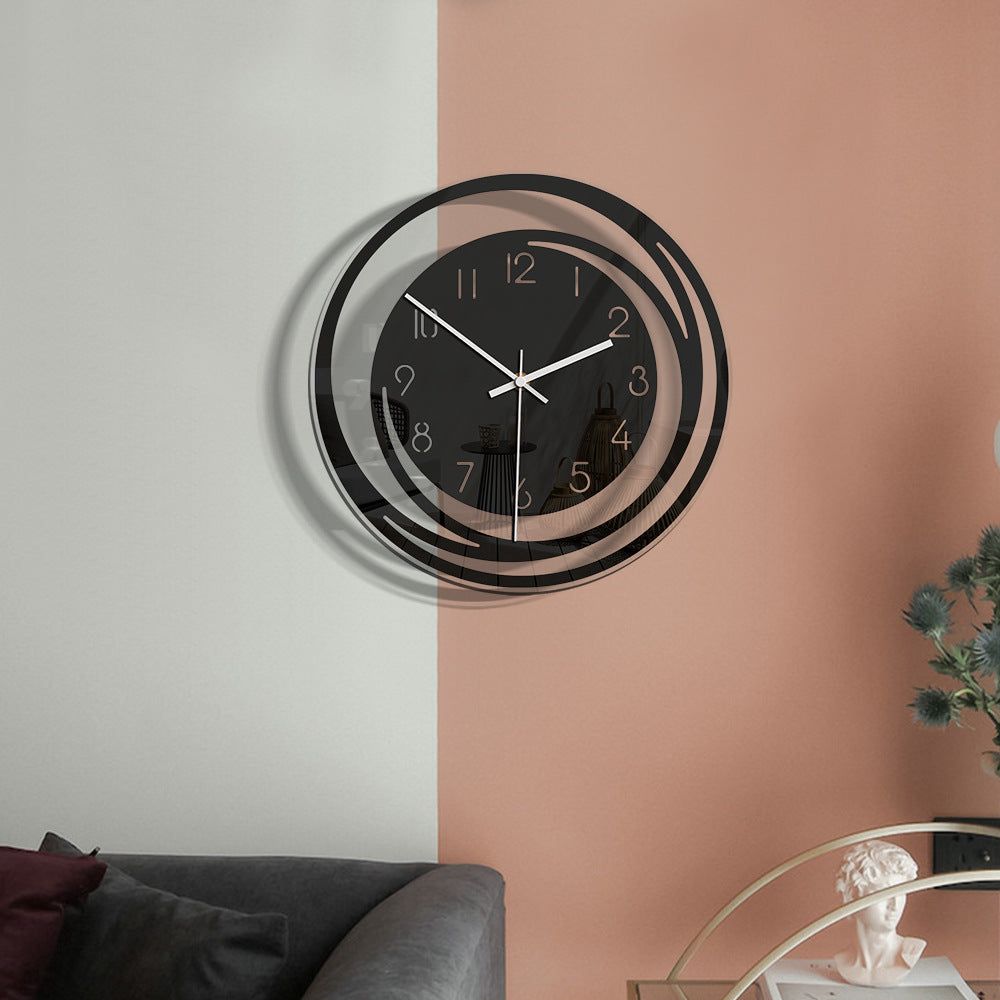 Modern wall clock with black and silver design on a two-tone wall.