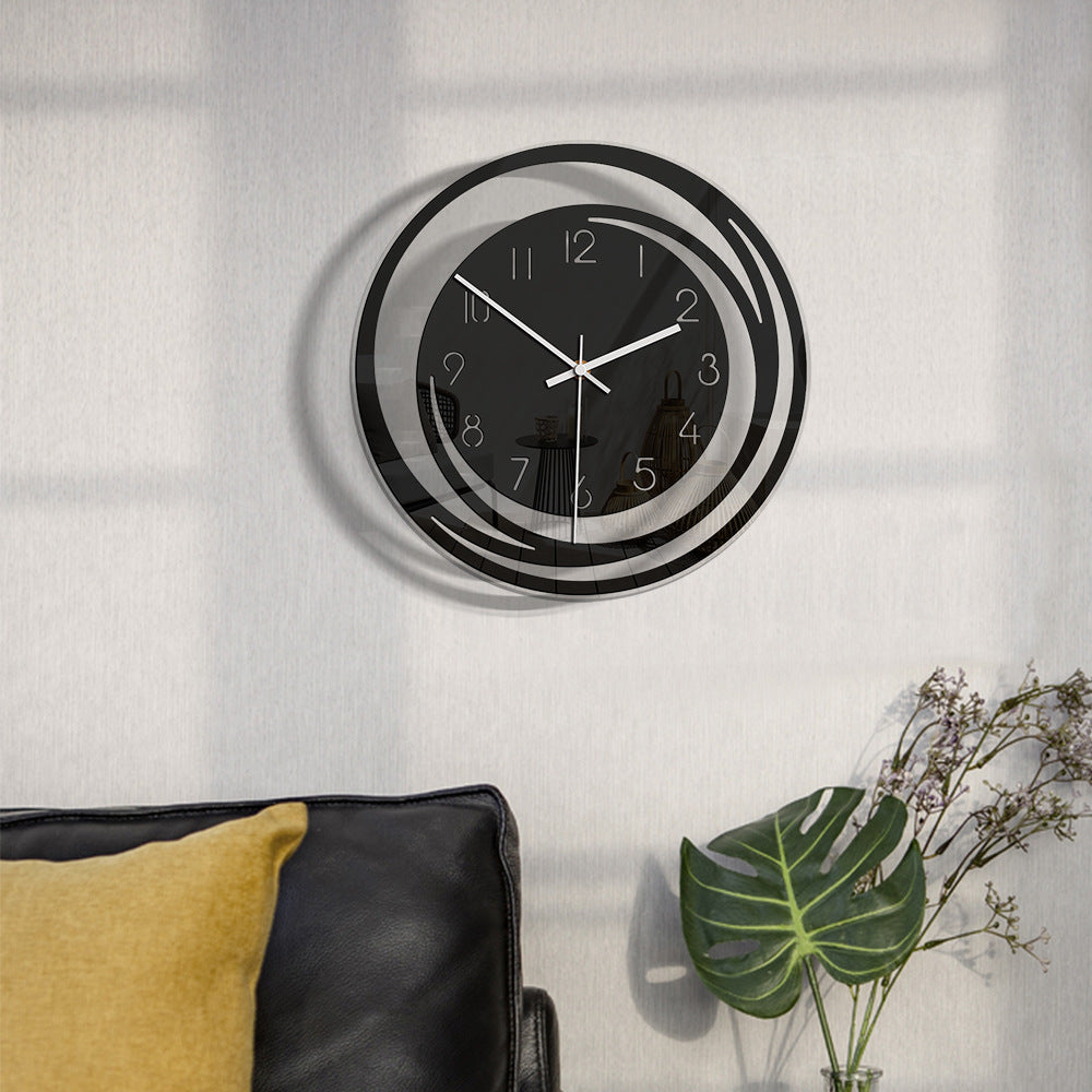 Modern wall clock on a light gray wall with decorative elements below.