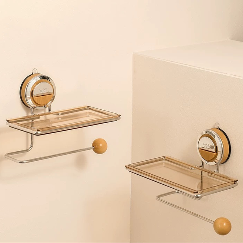 Two wall-mounted glass shelves with gold accents on a beige wall.