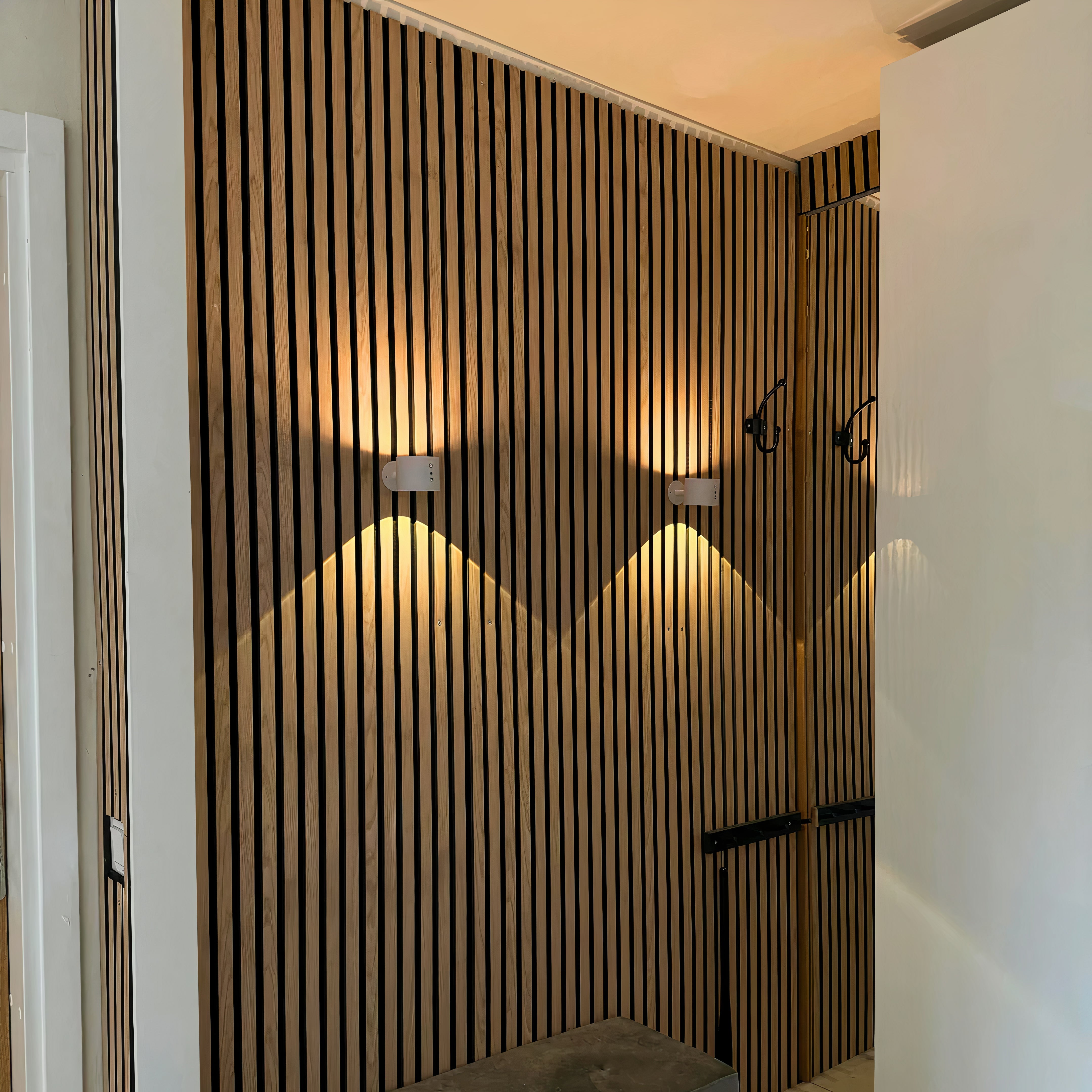Wooden slat wall with lighting fixtures in a modern interior setting