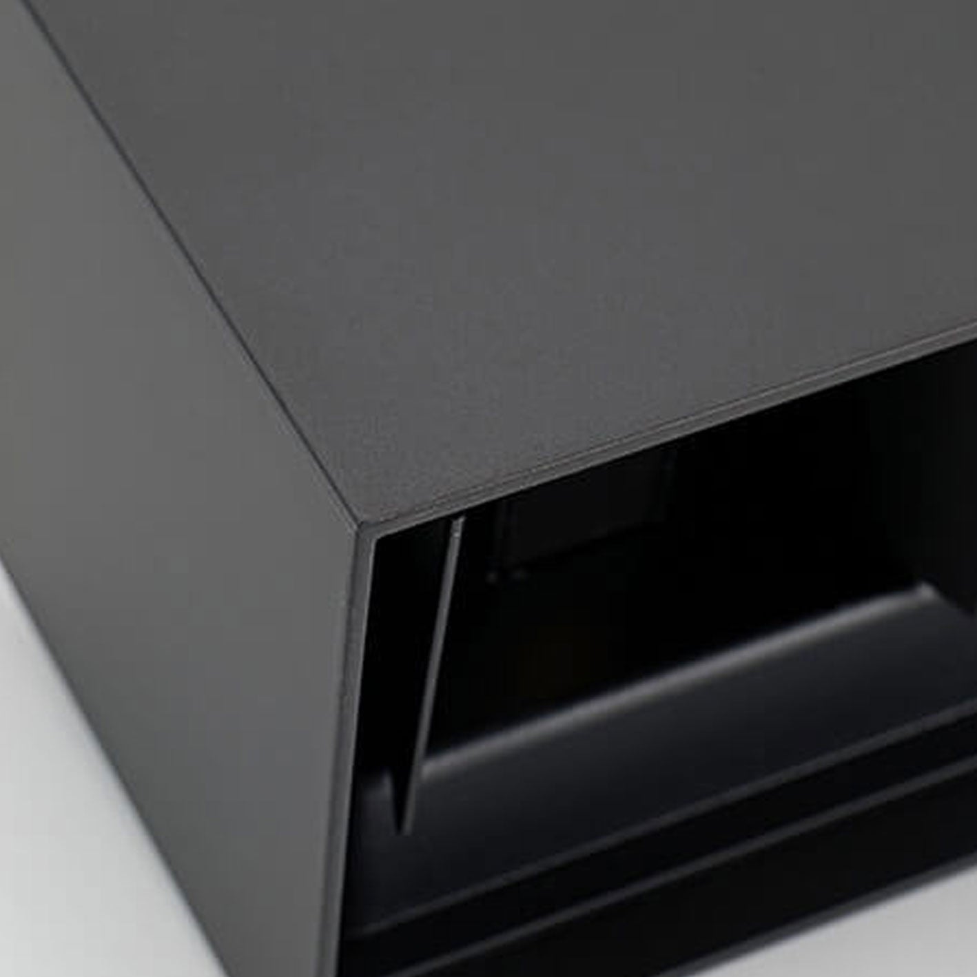 Close-up of a dark gray metal surface with a textured finish