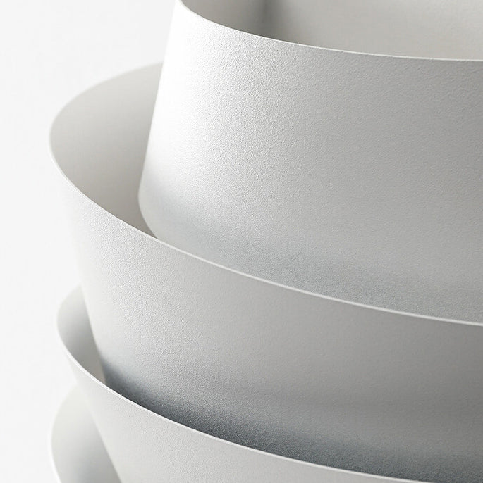 Stack of white bowls on a light gray background