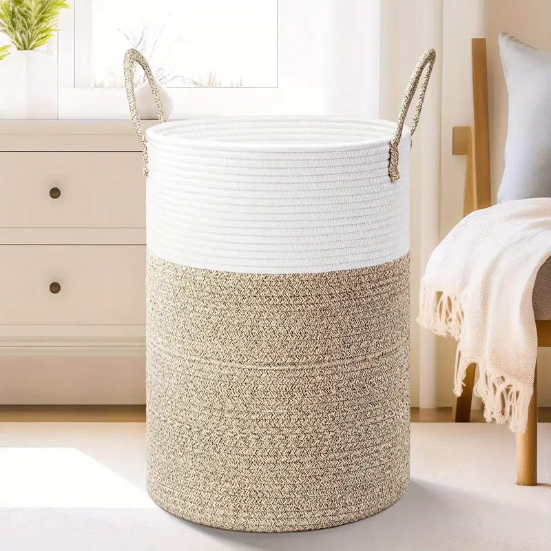 Woven laundry basket with white top and natural bottom in a room setting.