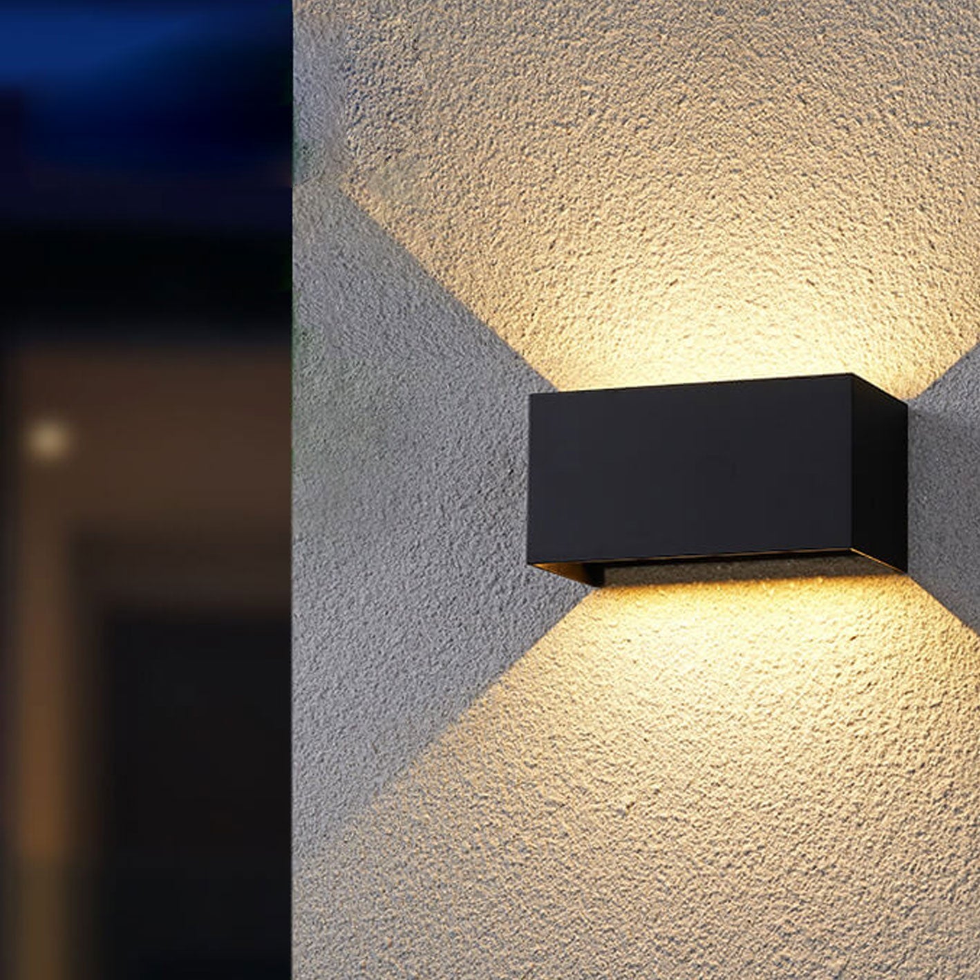 Black outdoor wall light fixture on a textured wall