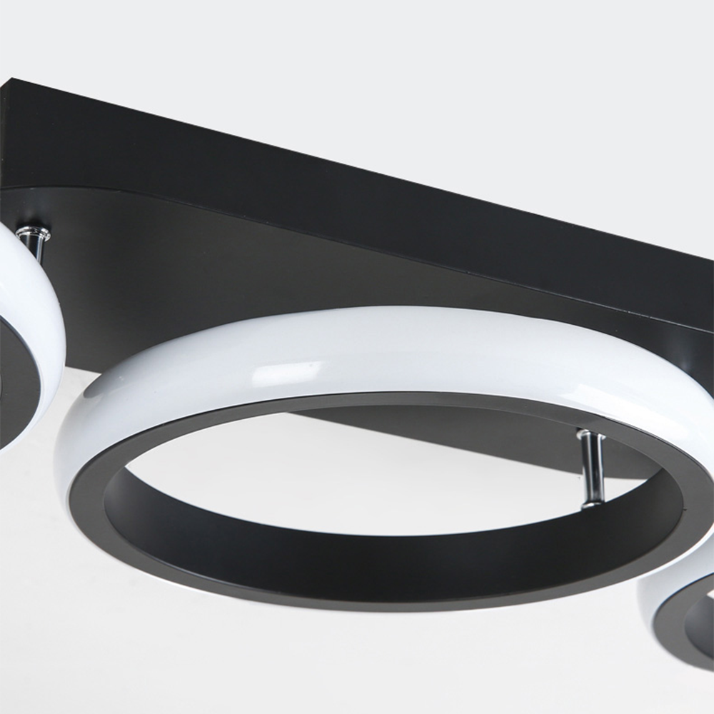 Modern ceiling light fixture with black and white design on a white background