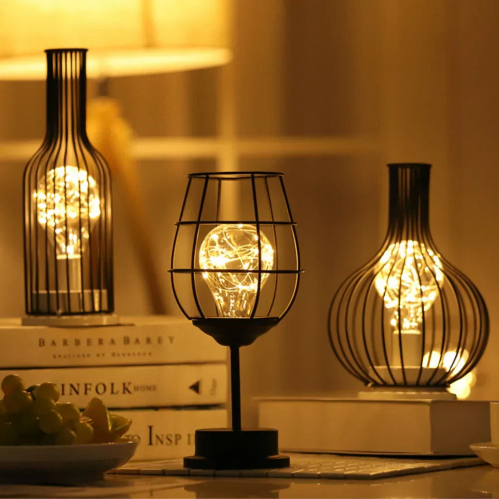Decorative lamps with glowing bulbs on a table with books in the background