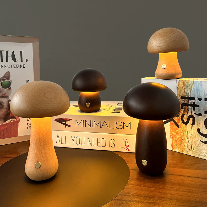 Mushroom-shaped lamps on a wooden surface with books in the background