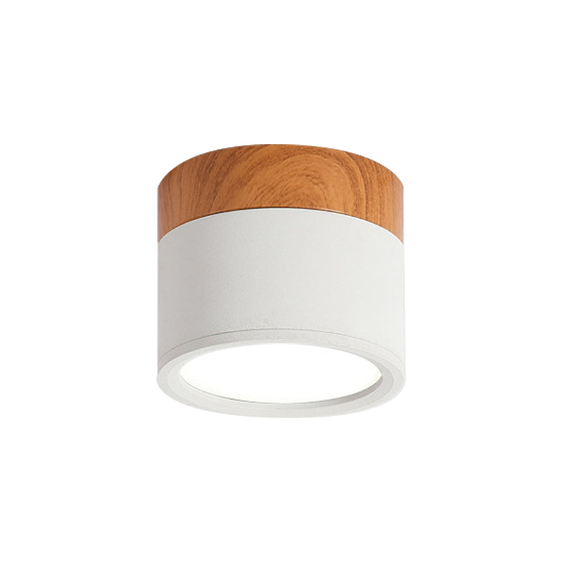 Ceiling light fixture with wooden top and white base on a white background