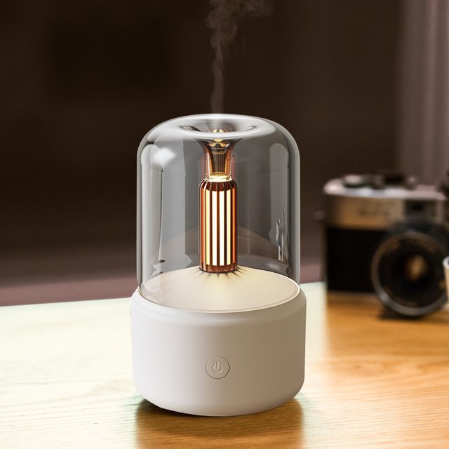 Small humidifier with a glass cover on a wooden surface