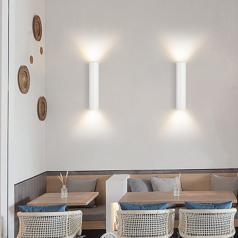 Modern restaurant interior with tables, chairs, and wall decorations.