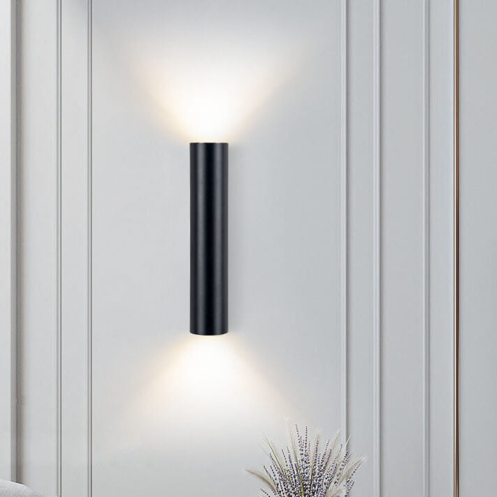 Modern wall-mounted light fixture on a white paneled wall.