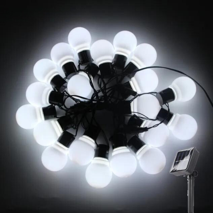 String of white light bulbs on a black background