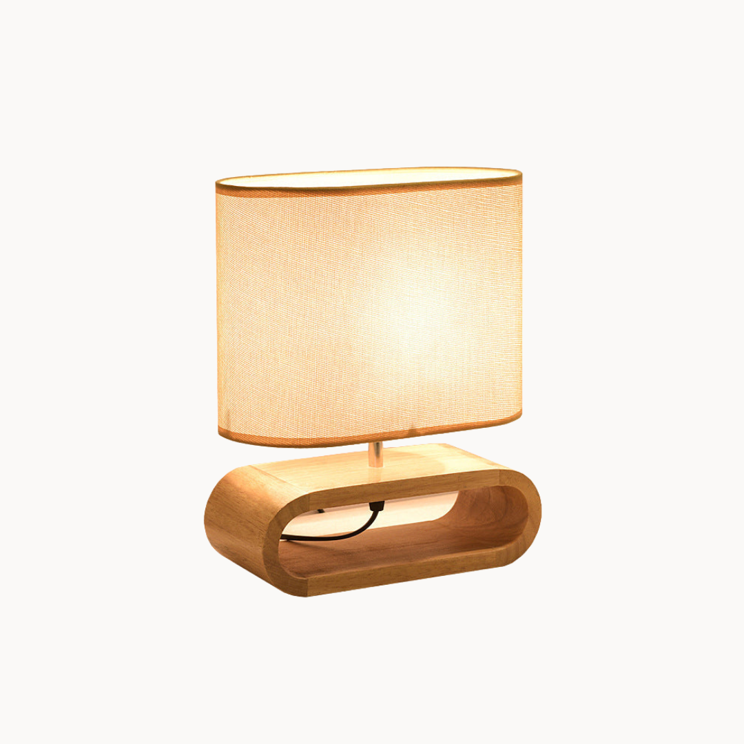 Table lamp with a beige shade and wooden base on a white background